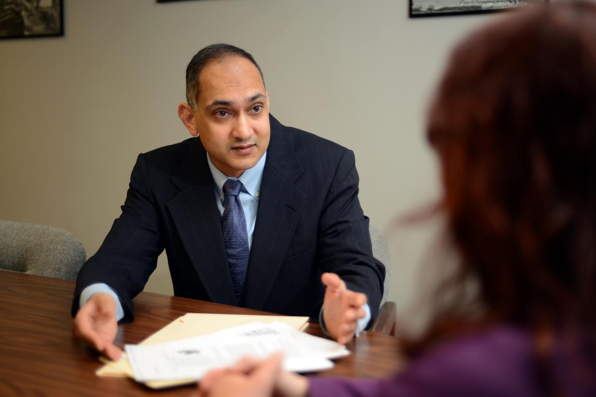 Attorney Jay Sheth consulting with a client